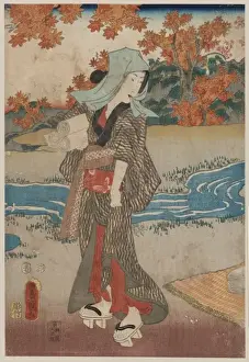 A woman beneath maple leaves