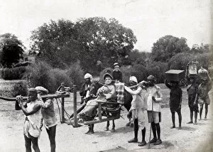 Woman in carrying chair, sedan, litter, with porters, India