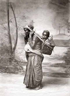 Woman carrying a child in a basket, India, c. 1880 s