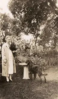 Woman with a dog in a garden