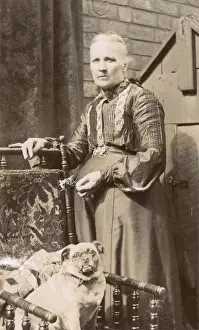 Woman with a dog in a back garden