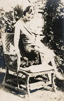 Woman with a dog in a garden