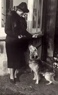 Woman and dog outside house