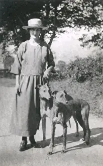 Woman with two dogs on a country lane