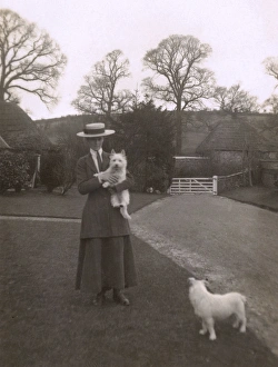 Images Dated 9th October 2015: Woman with two dogs in a garden