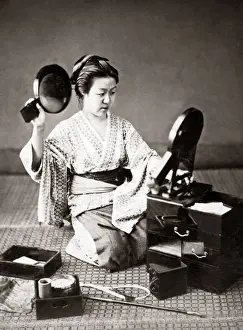 Woman doing her hair with two mirrors, Japan, circa 1880s. Date: circa 1880s