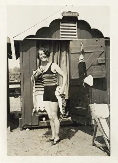 Images Dated 1st August 2017: Woman drying herself after a dip in the sea outside her hut