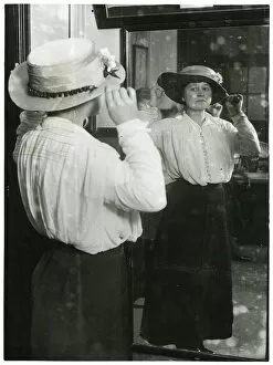 Woman examining her hat in a mirror