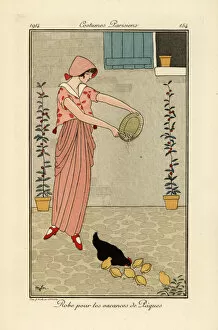Brock Collection: Woman feeding chickens in dress for the Easter holiday