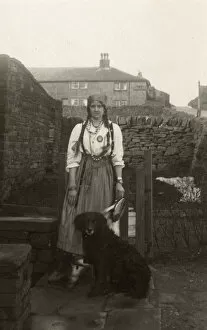 Plait Gallery: Woman in gipsy costume with a dog in a garden