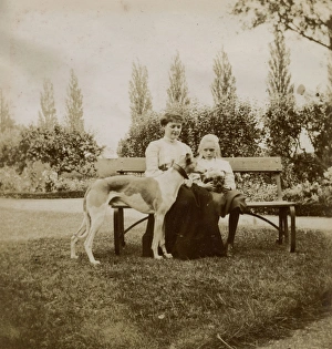 Woman and girl with dog and cat on a garden bench
