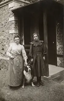 Sheepdogs Prints: Woman and girl with sheepdog outside a house, France