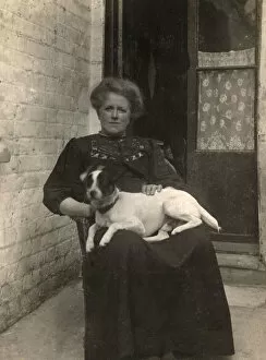 Russell Gallery: Woman with a Jack Russell terrier outside a house