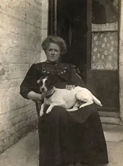 Whitewashed Prints: Woman with a Jack Russell terrier outside a house