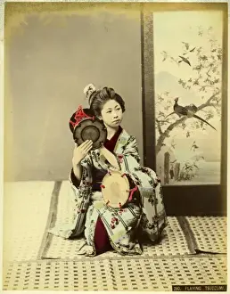 Woman in kimono playing tsudzumi