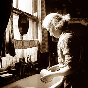 Sink Prints: Woman at a kitchen sink, probably 1930s