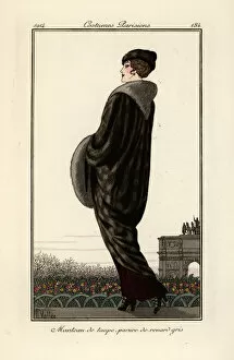 Woman in long coat of grey fox fur