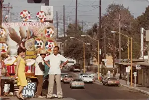 Woman and two men standing on the float above the street