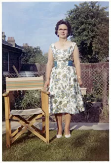 Insert Collection: Woman in a neat suburban garden with garden chair