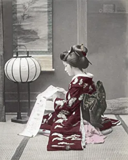 Woman in ornate kimono reading, Japan, c. 1880 s