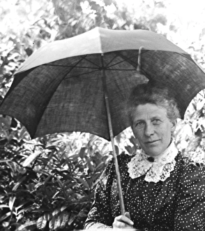 Images Dated 4th March 2015: Woman with a parasol in a garden