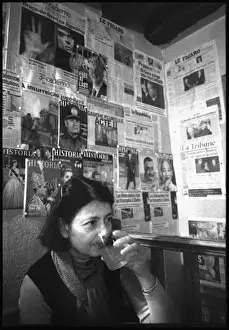 Shone Prints: Woman in Paris cafe - walls covered in political posters