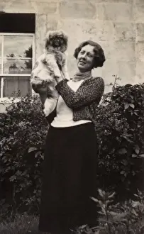 Woman with Pekingese dog in a garden