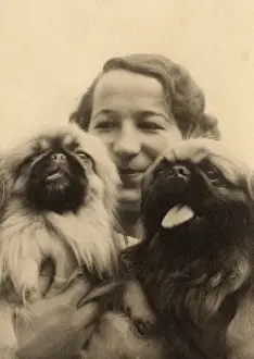 Woman with two Pekingese dogs