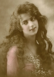 Lily Gallery: Woman in pink dress holding a bunch of lily of the valley