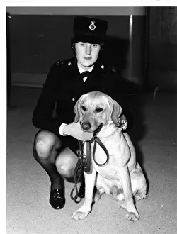 Woman police dog handler with drug sniffer dog, London