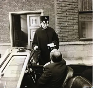 Woman police officer with car driver on a London street