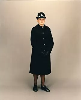 Woman police officer in coat and bowler hat, London