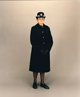 Duty Prints: Woman police officer in coat and bowler hat, London