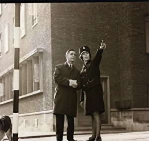 Woman police officer giving directions on a London street