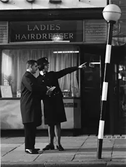 Woman police officer giving directions on a London street