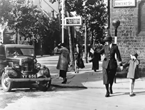 Smaller Prints: Woman police officer guiding little girl across the road