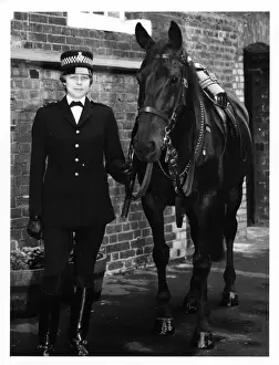 Woman police officer with horse, London