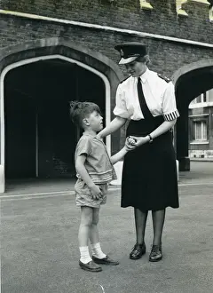 Archway Prints: Woman police officer with little boy, London