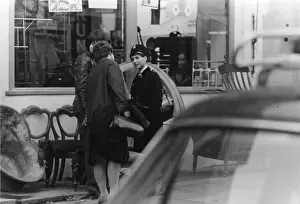Handbag Prints: Woman police officer outside a furniture shop, London