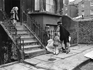 Handbag Prints: Woman police officer outside a house with two children