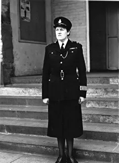 Shabby Gallery: Woman police officer outside police station, London