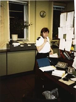 Policewomen Gallery: Woman police officer on the phone in a police station