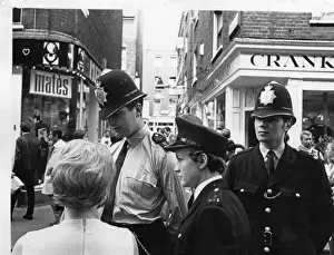 Woman police officer in street, London