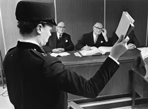 Swearing Collection: Woman police officer taking oath in court, London
