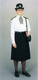 Woman police officer in white shirt and bowler hat, London