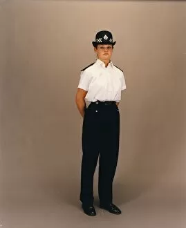 Equality Gallery: Woman police officer in white shirt and bowler hat, London