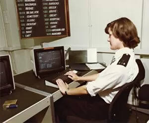 Woman police officer at work in communications room