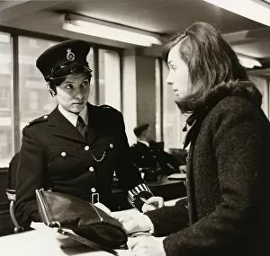 Armbands Gallery: Woman police officer at work in a London police station