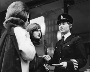 Armbands Gallery: Woman police officer and two young women, London