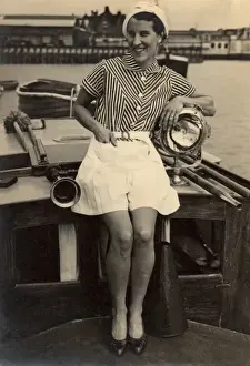 Woman poses on boat, 1930s